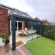 Veranda van aluminium met glazen wanden in nieuwbouwtuin in Boxtel
